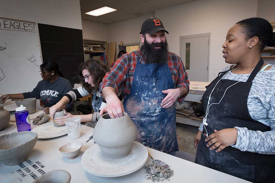 Faculty member working with student at table