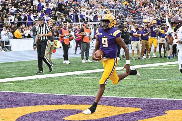 WCU Football Player kicking the ball