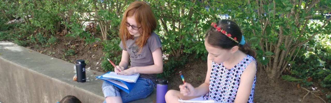 students writing in notebooks