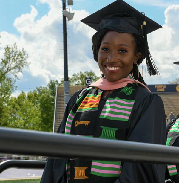 Student walking at graduation.